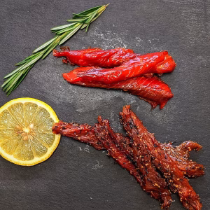 Wild Canadian smoked sockeye salmon candy and Indian pepper salmon gift duo on a serving board